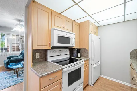 a kitchen with stainless steel appliances a stove a microwave and a sink