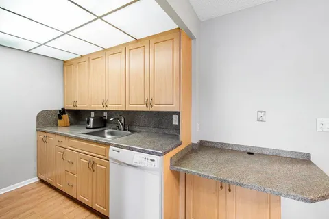 a kitchen with a sink and cabinets