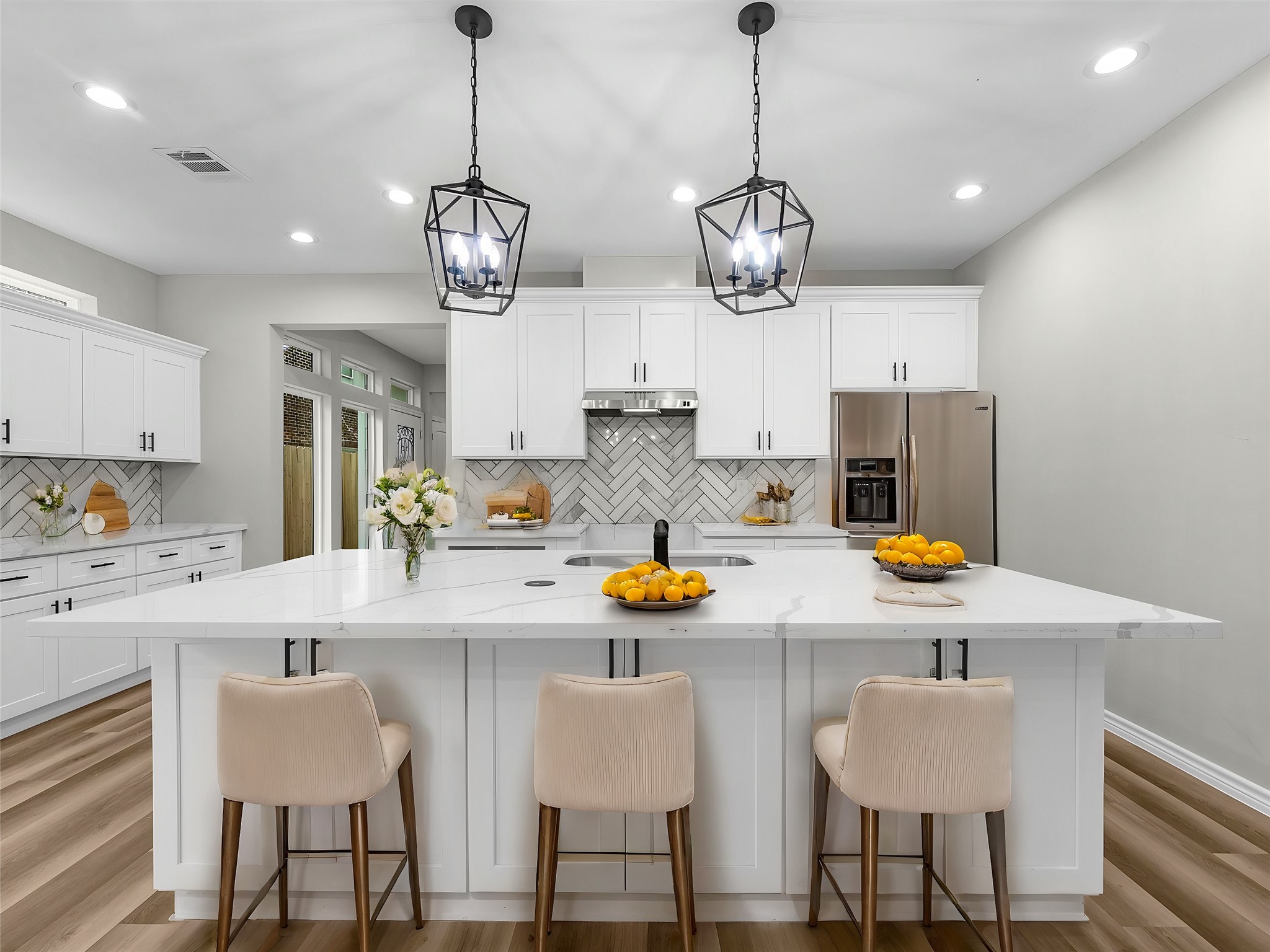 a kitchen with stainless steel appliances granite countertop a sink and a chandelier