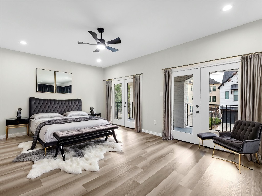 1319 West Bell Street Houston, TX 77019 - Photo 20 of 50 *Note* This photo is virtually staged*
This spacious, primary bright room features light vinyl flooring, modern recessed lighting, and a ceiling fan. Large double French doors open to a private balcony, providing ample natural light and an inviting view.