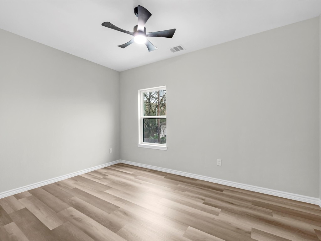 1319 West Bell Street Houston, TX 77019 - Photo 31 of 50 This bright room features light vinyl flooring and neutral walls, complemented by a modern ceiling fan and a window offering natural light.