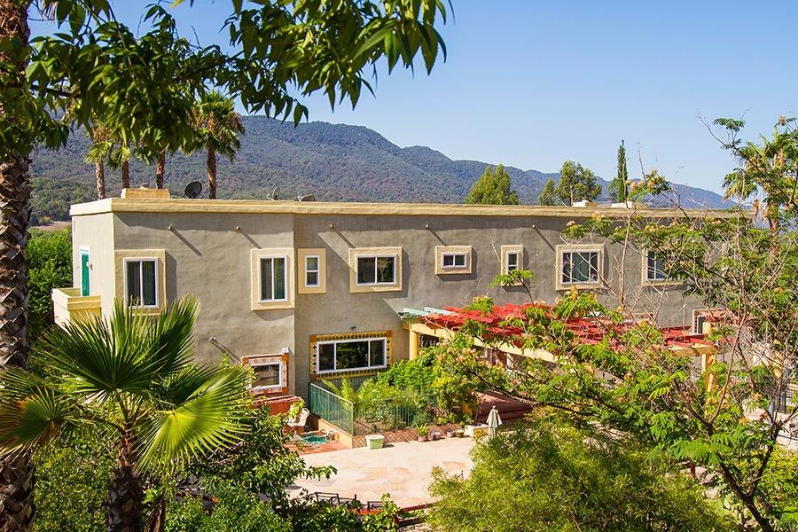 10075 Ojai Santa Paula Road Ojai, CA 93023 - Photo 16 of 17 a front view of a house with a garden