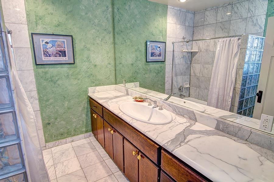10075 Ojai Santa Paula Road Ojai, CA 93023 - Photo 10 of 17 a bathroom with a granite countertop sink a mirror and shower