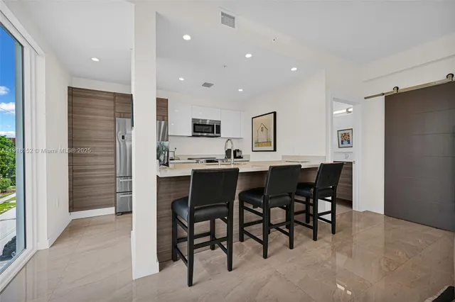 a kitchen with stainless steel appliances granite countertop a stove and a refrigerator