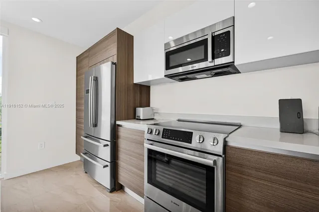 a kitchen with stainless steel appliances granite countertop white cabinets and stainless steel appliances