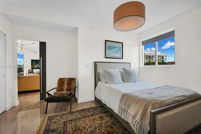 a bedroom with a bed and a painting on the wall