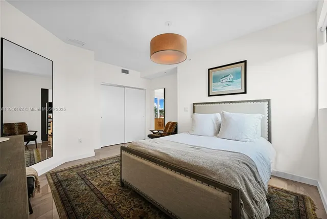 a bathroom with a granite countertop sink a toilet a mirror and a tub