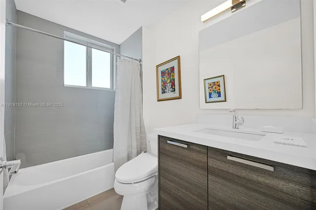 a bathroom with a toilet sink and shower