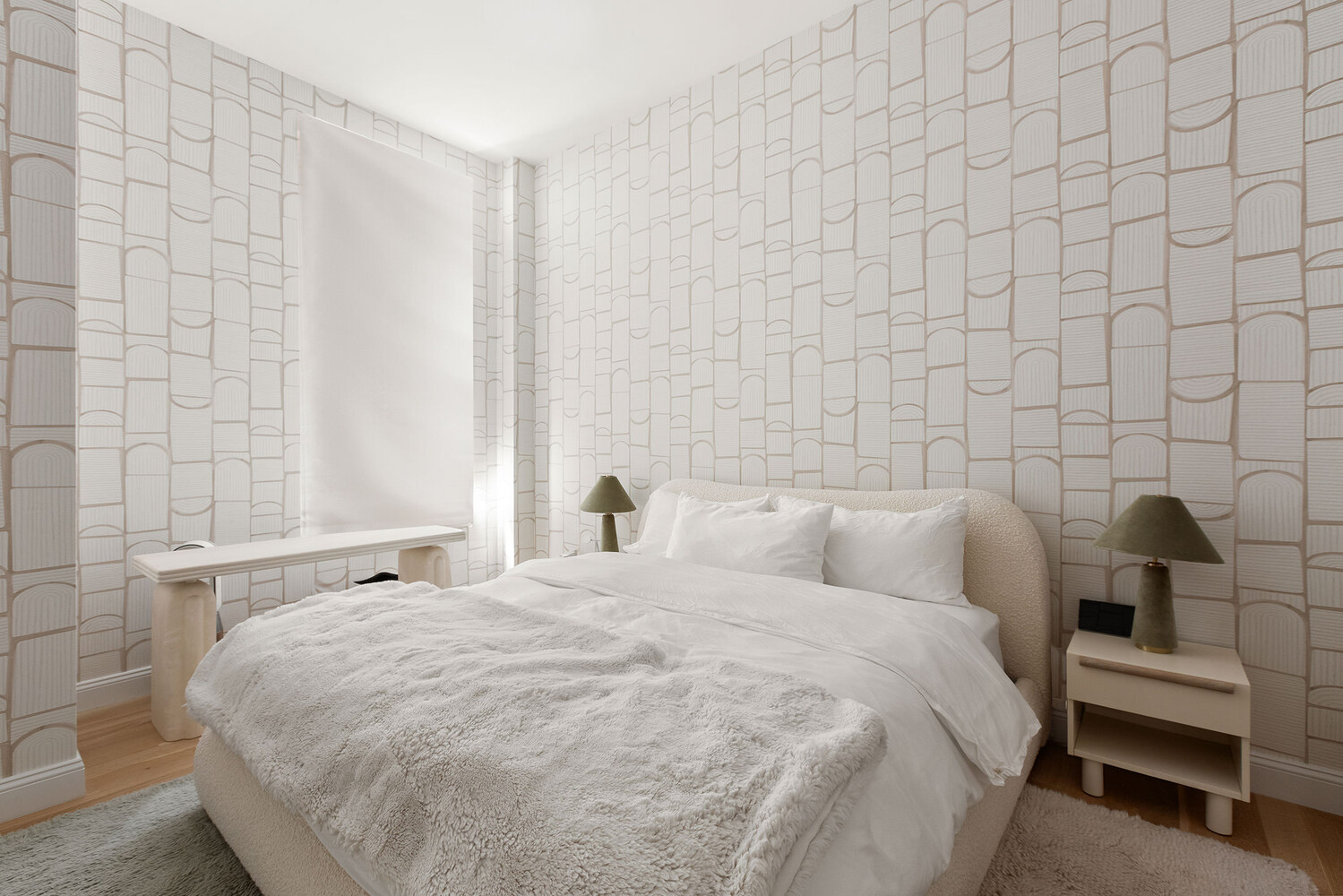 83 Spring Street, Unit 3 Manhattan, NY 10012 - Photo 16 of 24 a bedroom with a bed and a lamp on the dresser