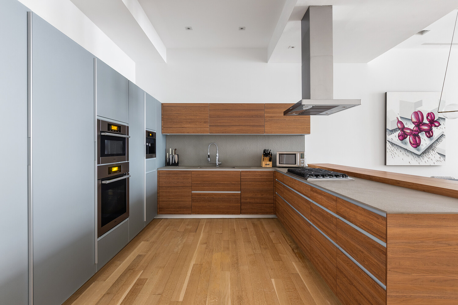 83 Spring Street, Unit 3 Manhattan, NY 10012 - Photo 18 of 24 a kitchen with stainless steel appliances a refrigerator and cabinets