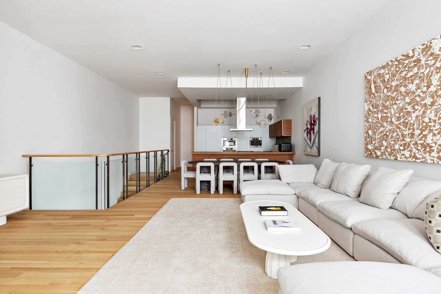 83 Spring Street, Unit 3 Manhattan, NY 10012 - Photo 19 of 24 a living room with furniture and a dining table with wooden floor