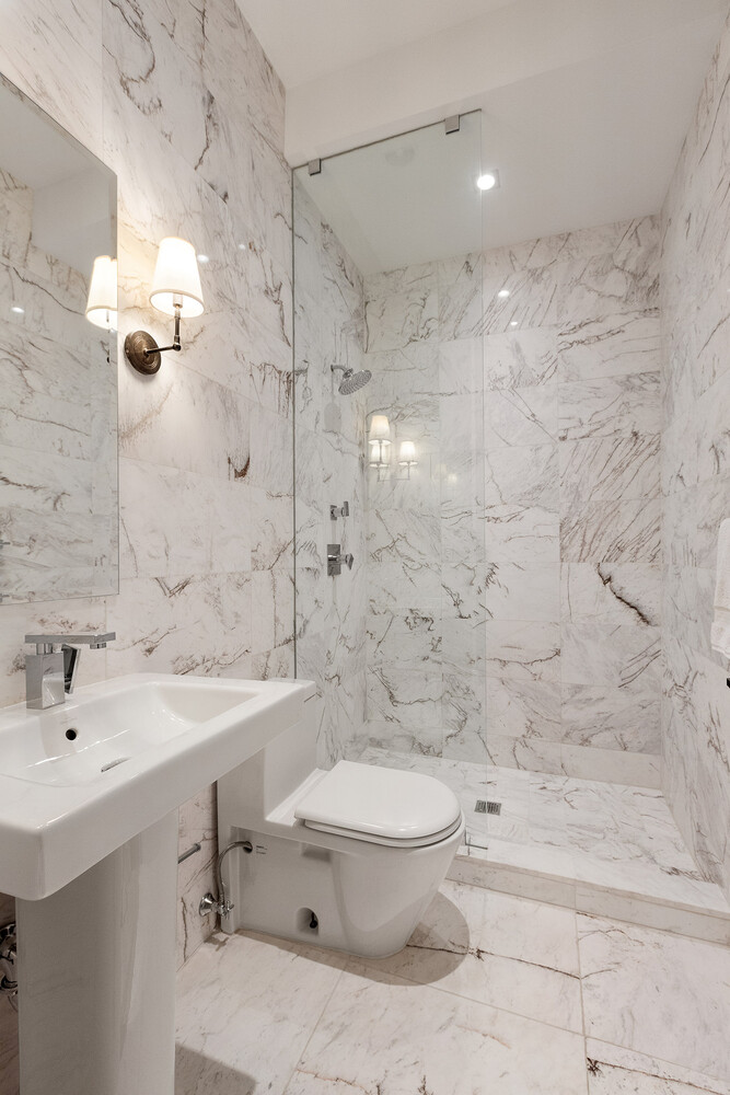 83 Spring Street, Unit 3 Manhattan, NY 10012 - Photo 22 of 24 a bathroom with a sink toilet and shower