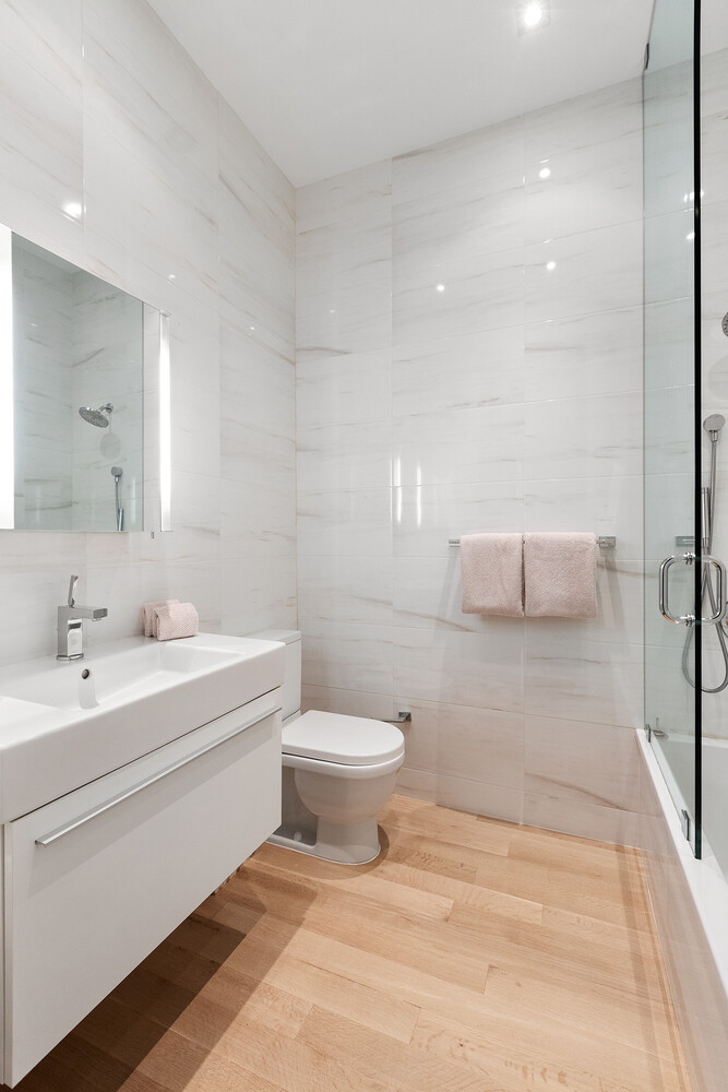 83 Spring Street, Unit 3 Manhattan, NY 10012 - Photo 23 of 24 a bathroom with a sink a toilet and mirror