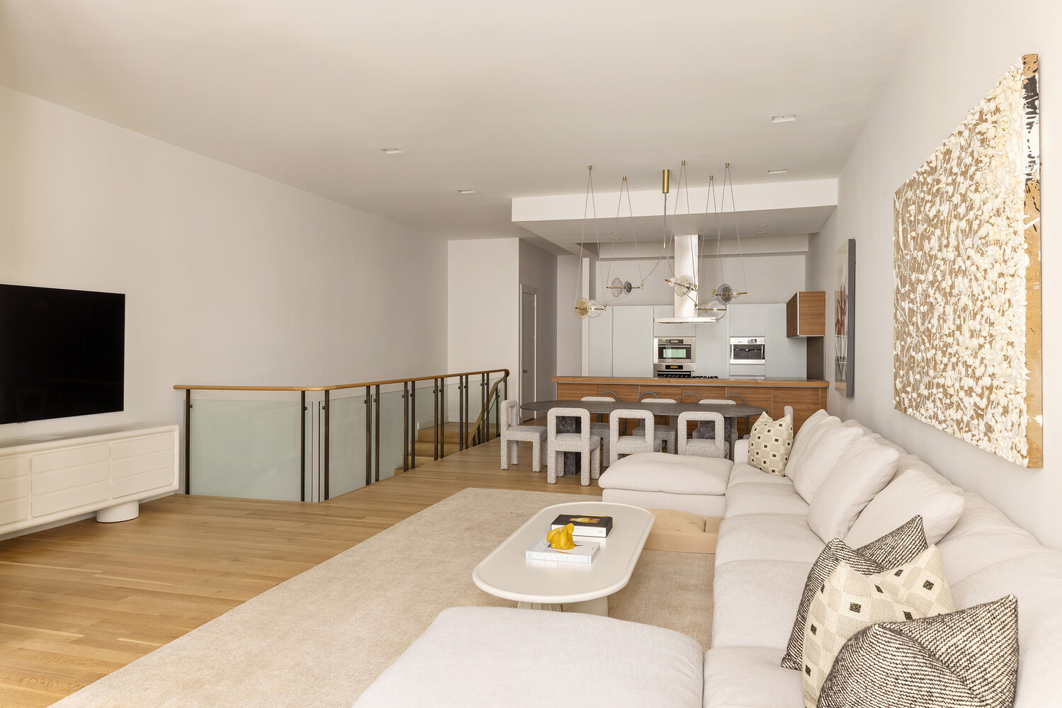 83 Spring Street, Unit 3 Manhattan, NY 10012 - Photo 7 of 24 a living room with furniture and a flat screen tv