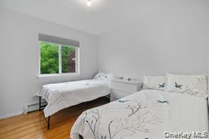 a bedroom with two beds and a window