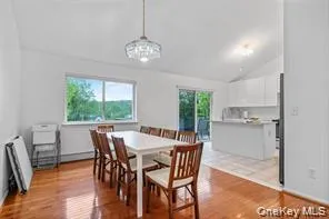 a view of a dining room with furniture window and wooden floor