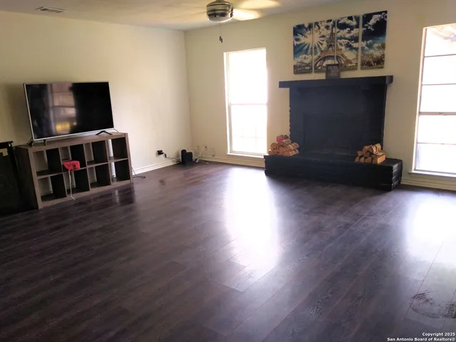a living room with hard wood floors and a window