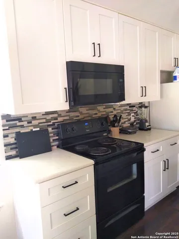 a kitchen with stainless steel appliances a stove and a microwave