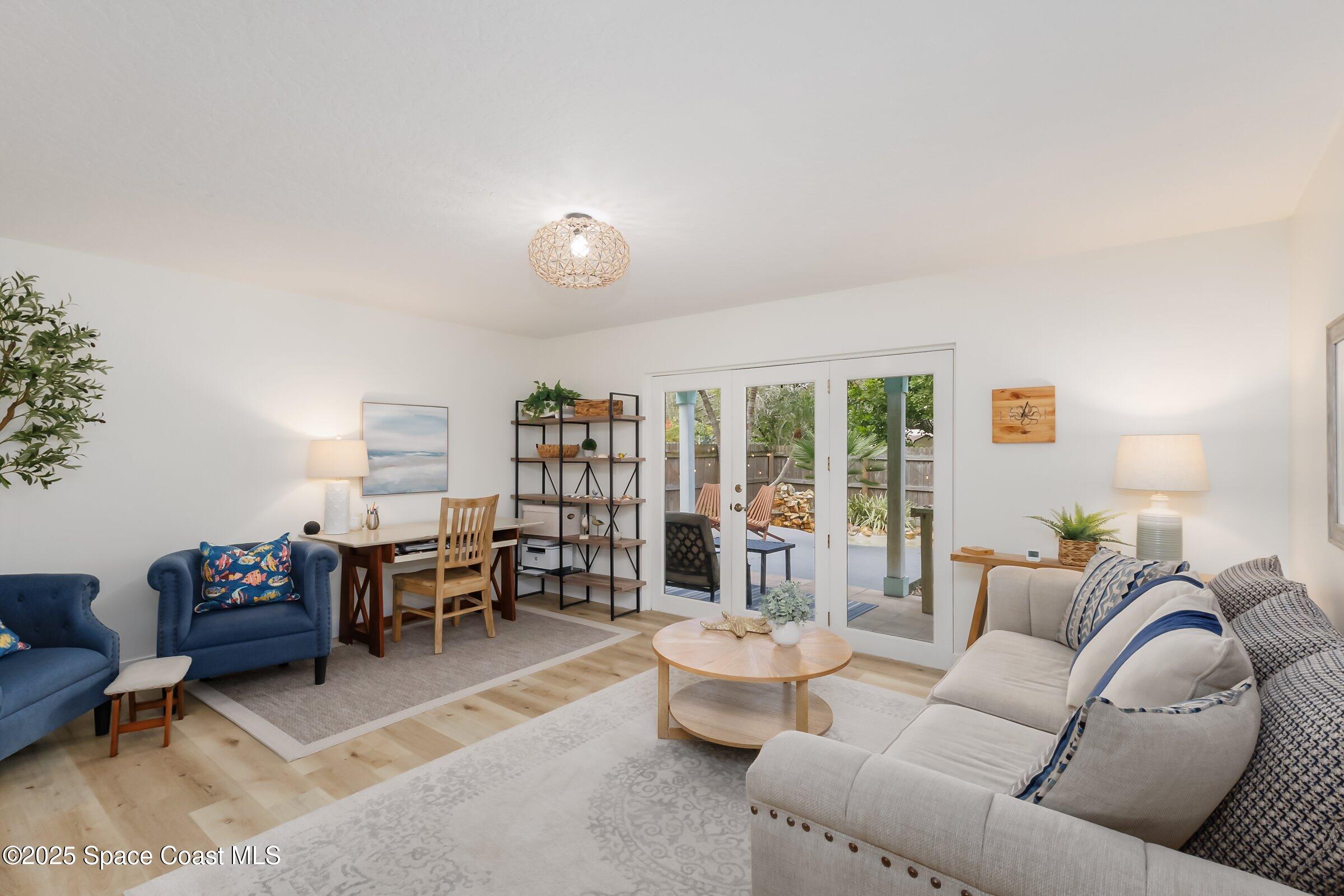 24 Olive Street Cocoa Beach, FL 32931 - Photo 11 of 50 a living room with furniture and a large window