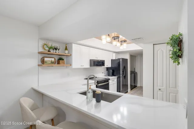 a kitchen with stainless steel appliances kitchen island granite countertop a sink and cabinets