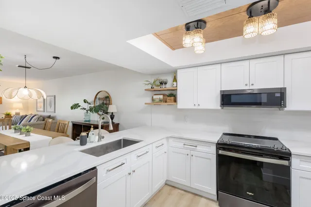 a kitchen with cabinets a sink and appliances