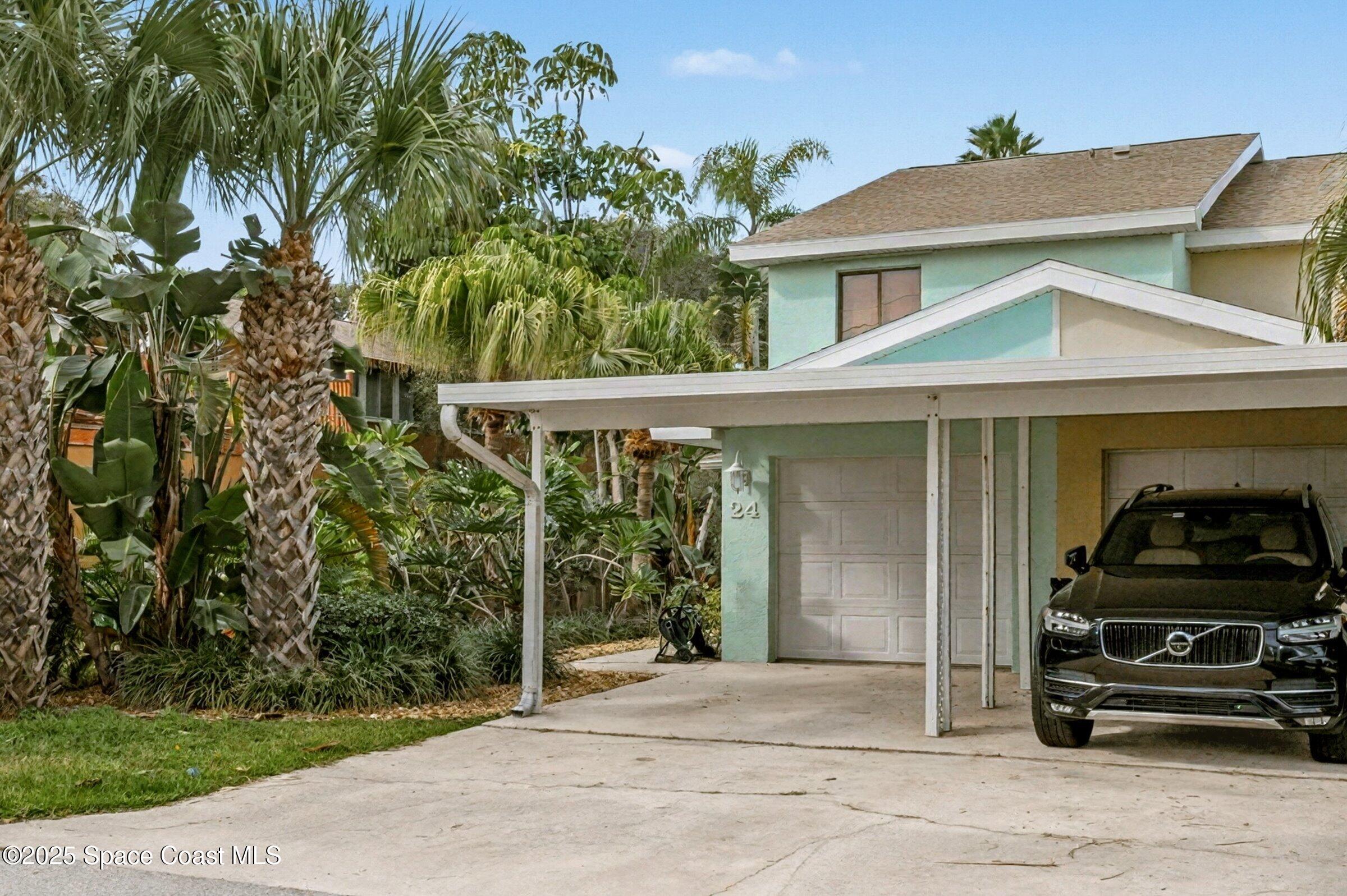 24 Olive Street Cocoa Beach, FL 32931 - Photo 2 of 50 a view of a car park in front of house