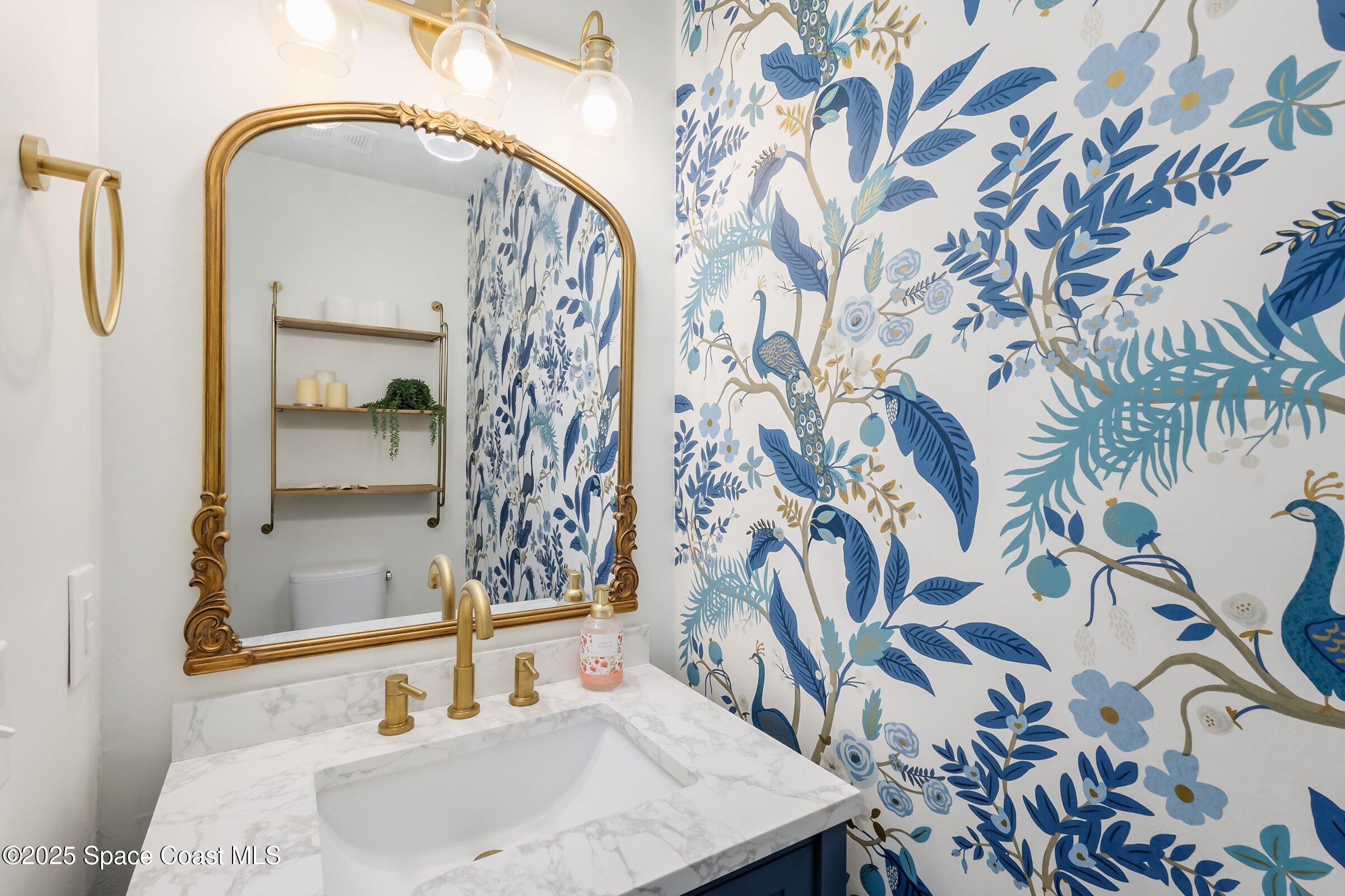 24 Olive Street Cocoa Beach, FL 32931 - Photo 22 of 50 a bathroom with a sink and a mirror