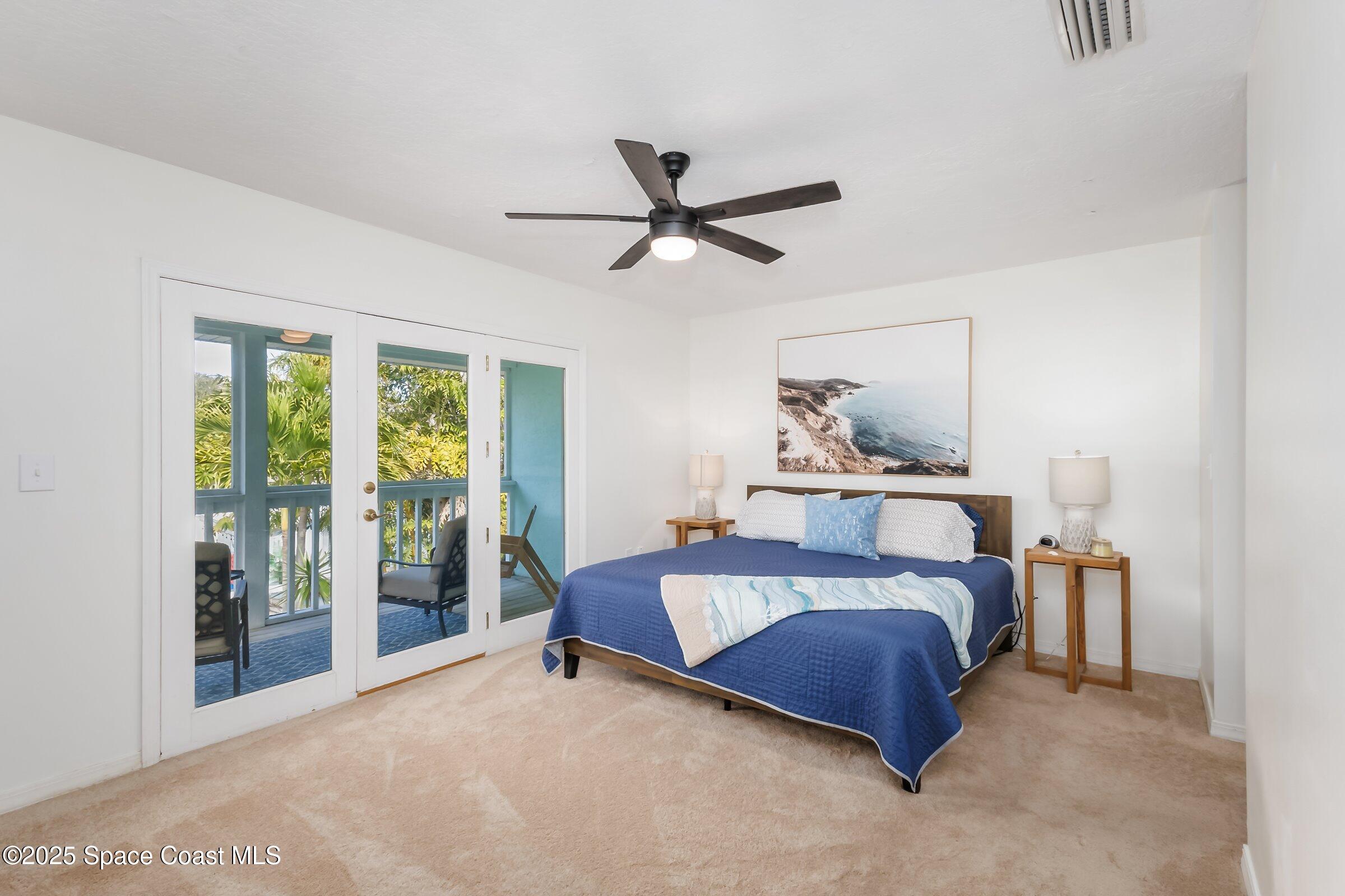 24 Olive Street Cocoa Beach, FL 32931 - Photo 23 of 50 a bedroom with a bed and a large window