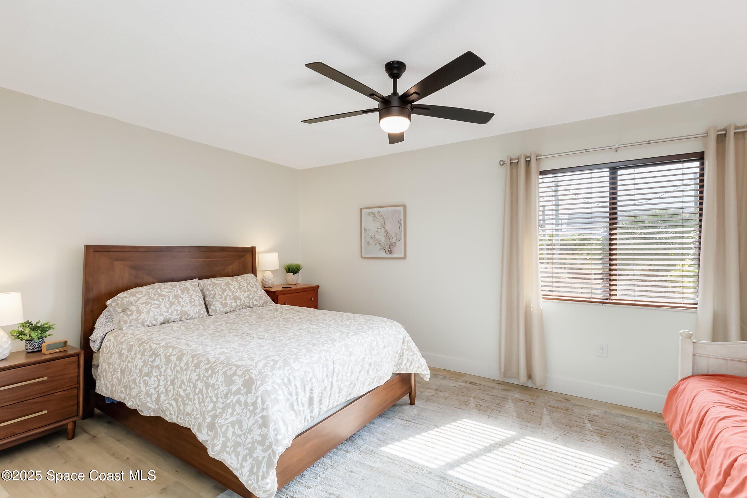 24 Olive Street Cocoa Beach, FL 32931 - Photo 27 of 50 a bedroom with a bed and window