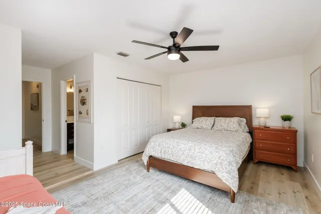 a bedroom with a bed and a ceiling fan