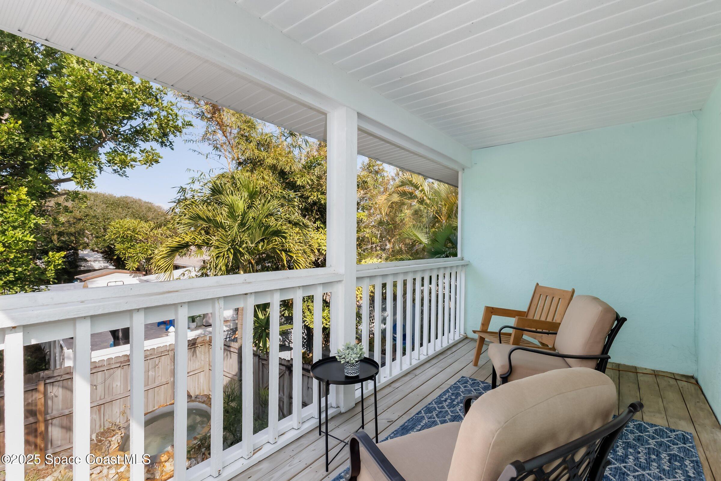 24 Olive Street Cocoa Beach, FL 32931 - Photo 31 of 50 a view of a chair and table in wooden floor