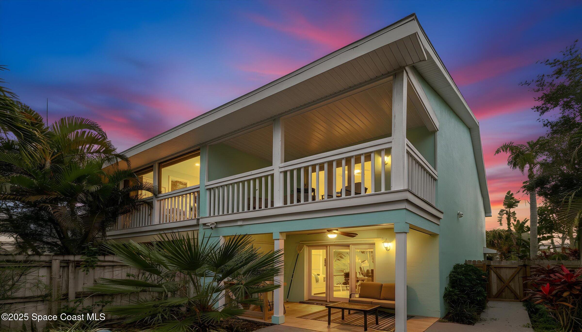 24 Olive Street Cocoa Beach, FL 32931 - Photo 35 of 50 a view of a house with a large window and potted plants