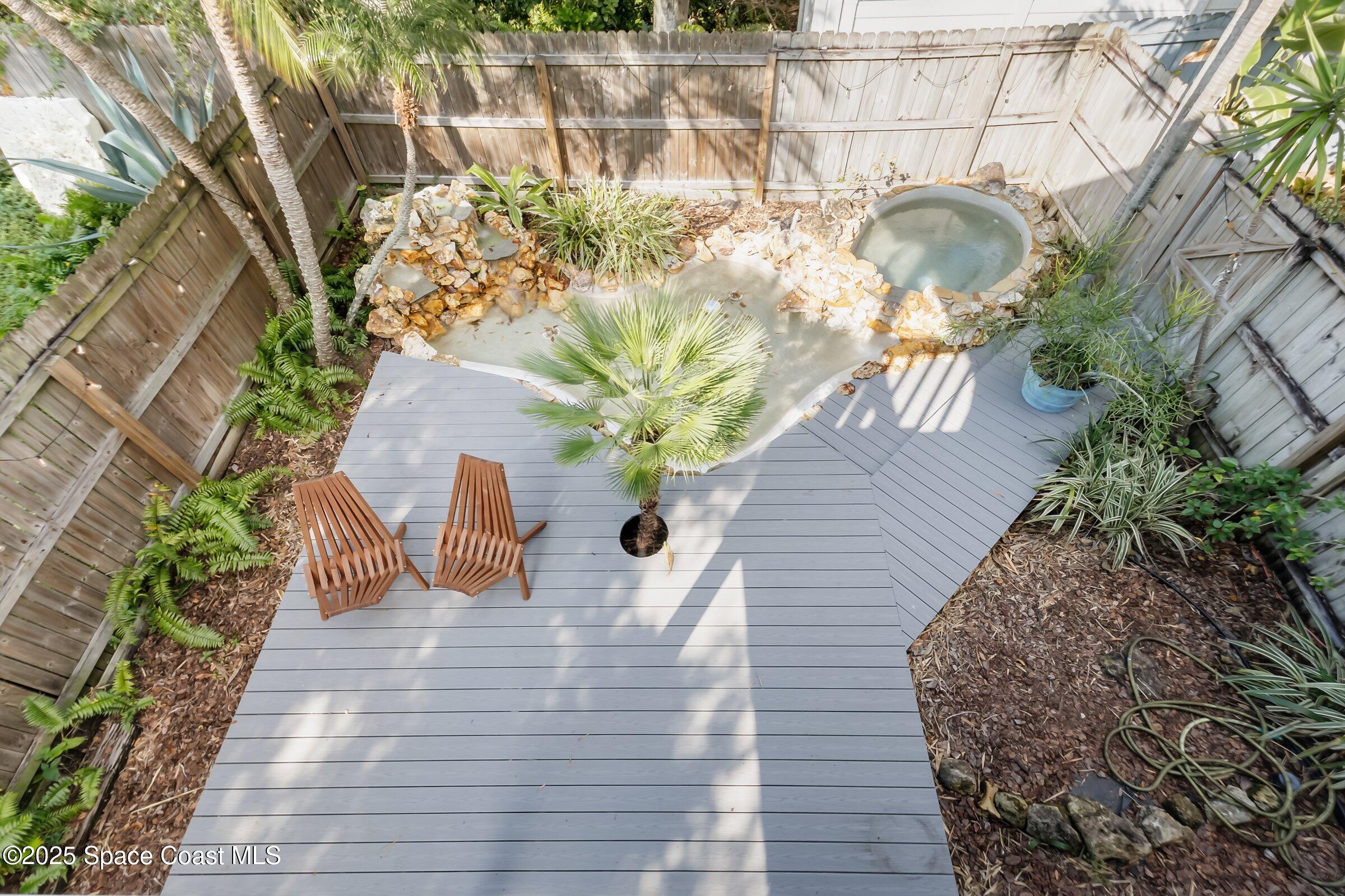 24 Olive Street Cocoa Beach, FL 32931 - Photo 37 of 50 a vase of flowers sitting on a wooden floor
