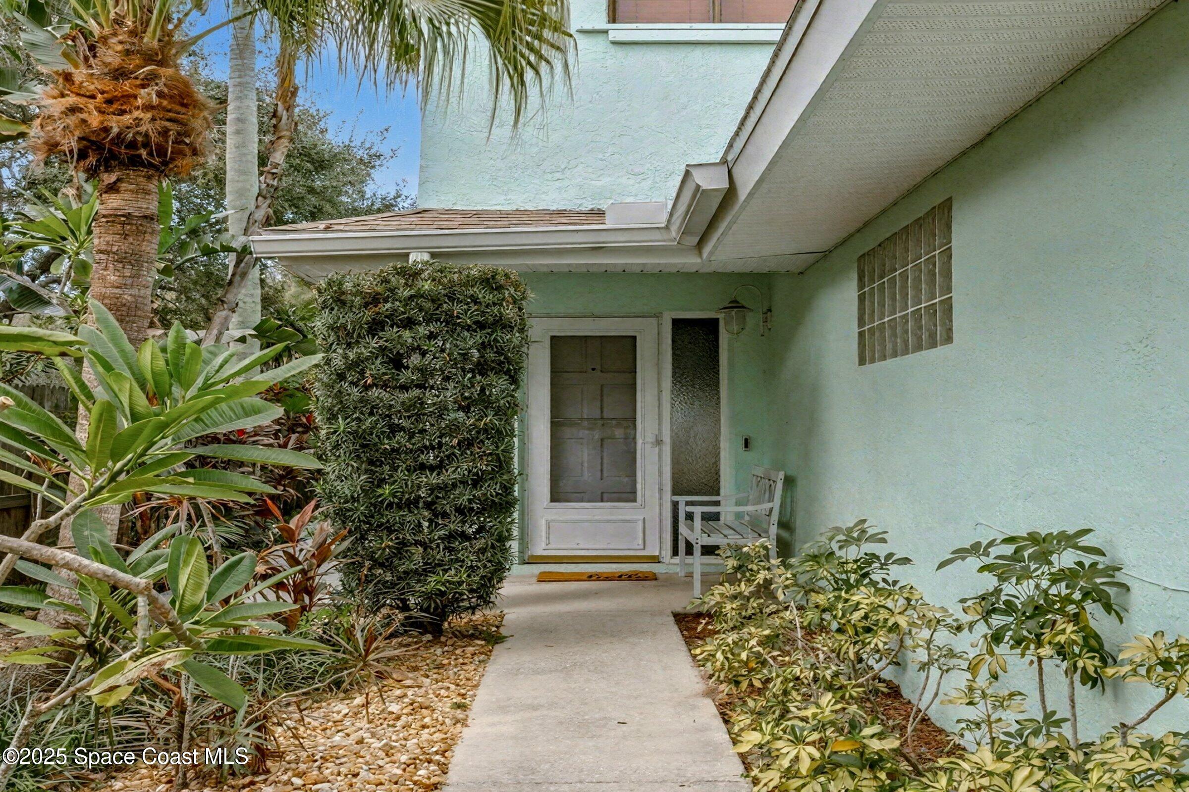 24 Olive Street Cocoa Beach, FL 32931 - Photo 6 of 50 a front view of a house with a yard