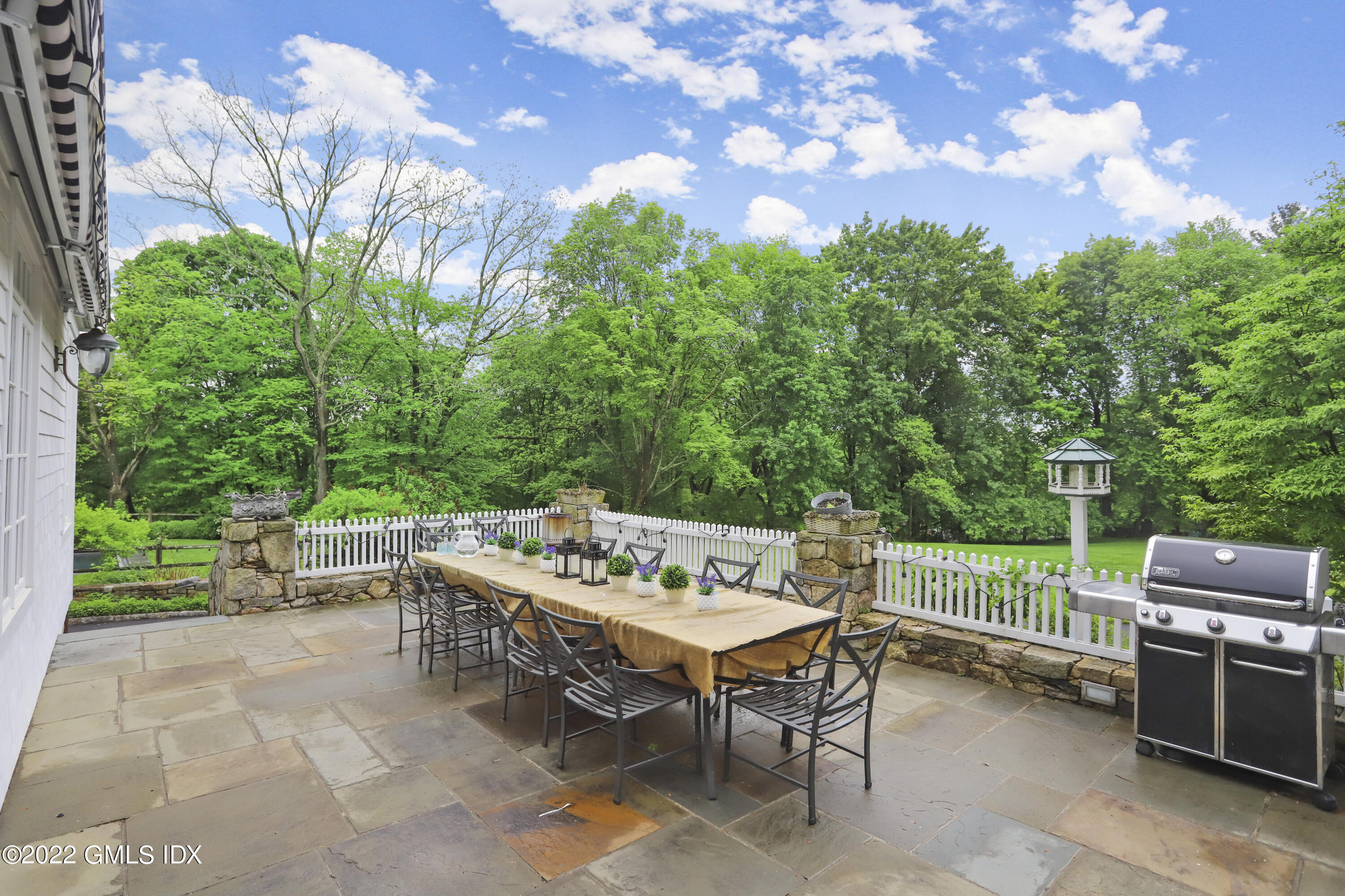 331 Round Hill Road Greenwich, CT 06831 - Photo 19 of 28 a view of a chairs and table in the back yard of the house