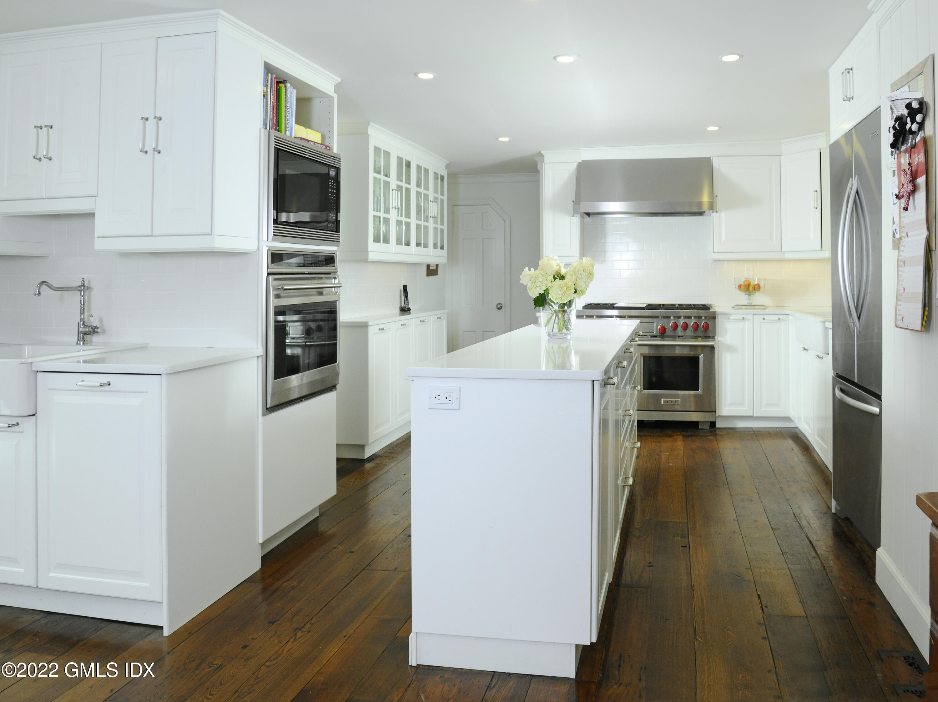 331 Round Hill Road Greenwich, CT 06831 - Photo 3 of 28 a kitchen with cabinets and wooden floor