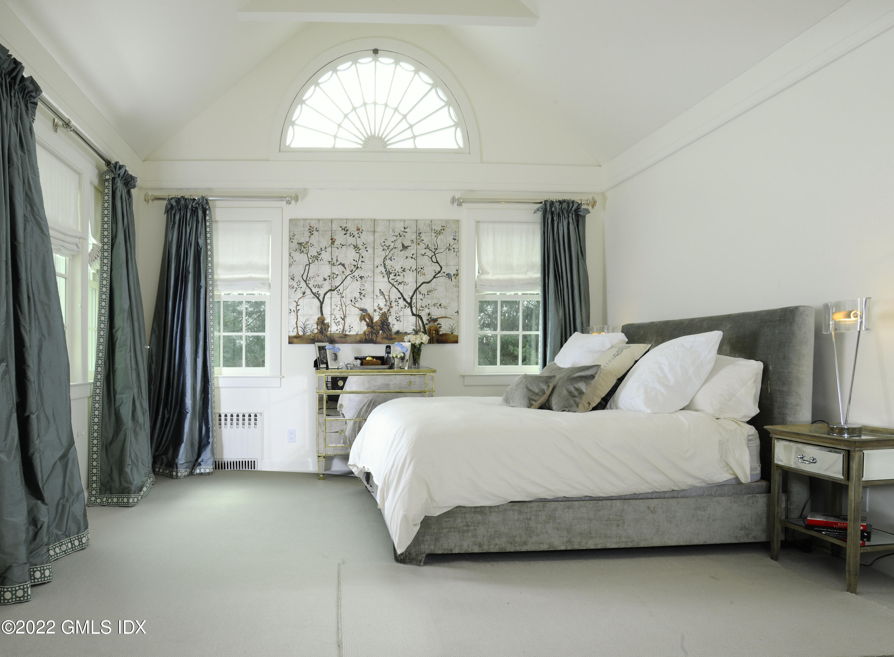 331 Round Hill Road Greenwich, CT 06831 - Photo 9 of 28 a bedroom with a large bed and a chandelier