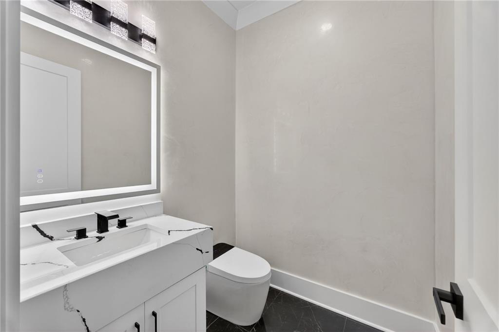 405 Thunder Road Buford, GA 30518 - Photo 78 of 104 a bathroom with a sink a toilet and a mirror