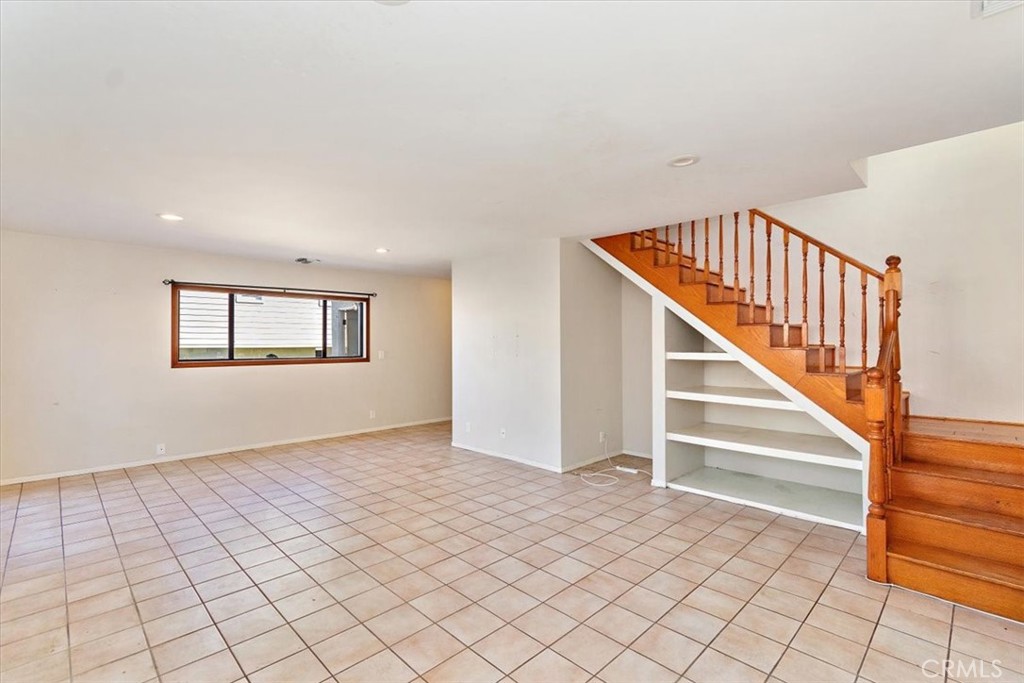 6027 West 76th Street Los Angeles, CA 90045 - Photo 14 of 36 Family Room with under stair shelving