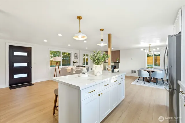 a large white kitchen with a large window