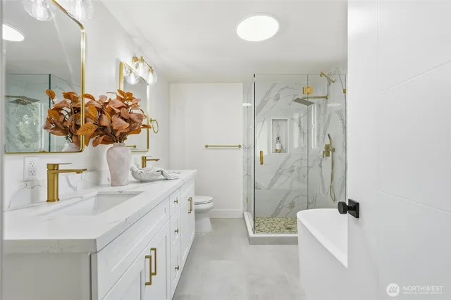 a bathroom with a double vanity sink mirror and toilet
