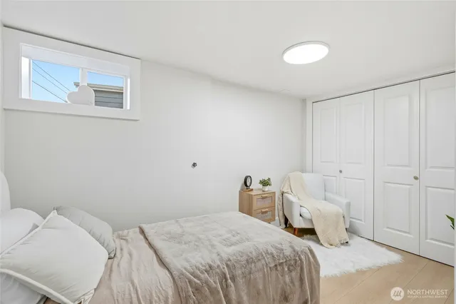 a bedroom with a bed and a night stand