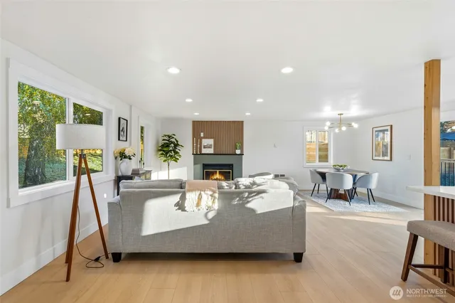 a living room with fireplace furniture and a wooden floor