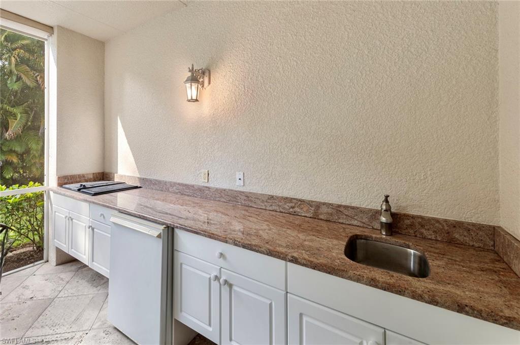 2370 Hidden Lake Court, Unit 8301 Naples, FL 34112 - Photo 17 of 21 Grill, refrigerator and sink on lanai