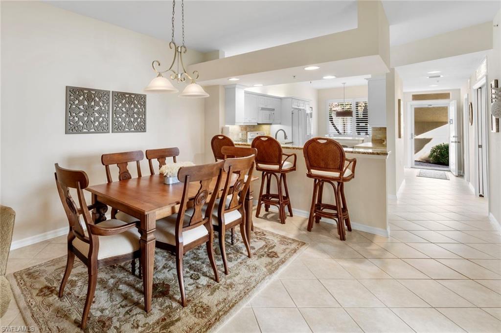 2370 Hidden Lake Court, Unit 8301 Naples, FL 34112 - Photo 10 of 21 Dining Table & Kitchen Eating Area