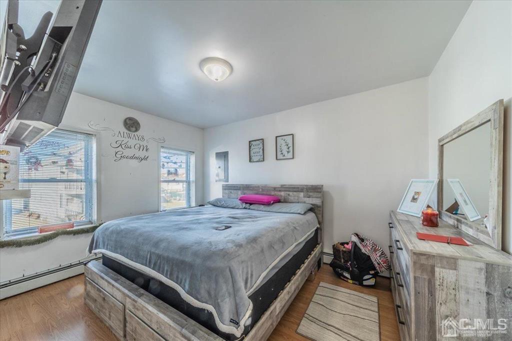 28 Union Street Carteret, NJ 07008 - Photo 12 of 25 a bedroom with a bed and wooden floor