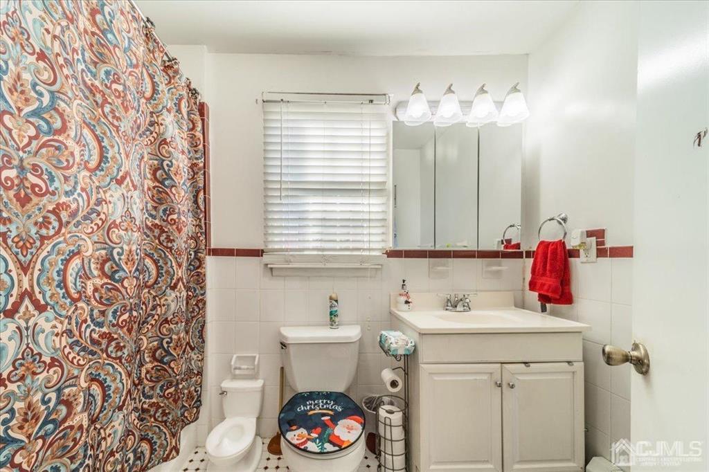 28 Union Street Carteret, NJ 07008 - Photo 17 of 25 a bathroom with a sink and a mirror