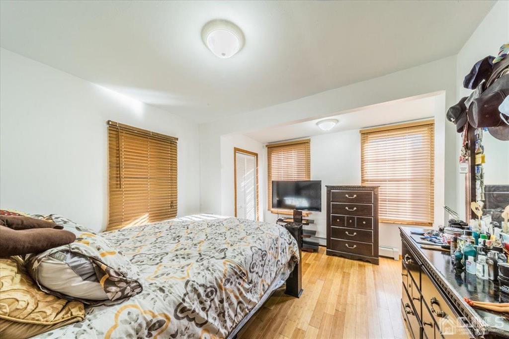 28 Union Street Carteret, NJ 07008 - Photo 18 of 25 a bedroom with a bed and wooden floor