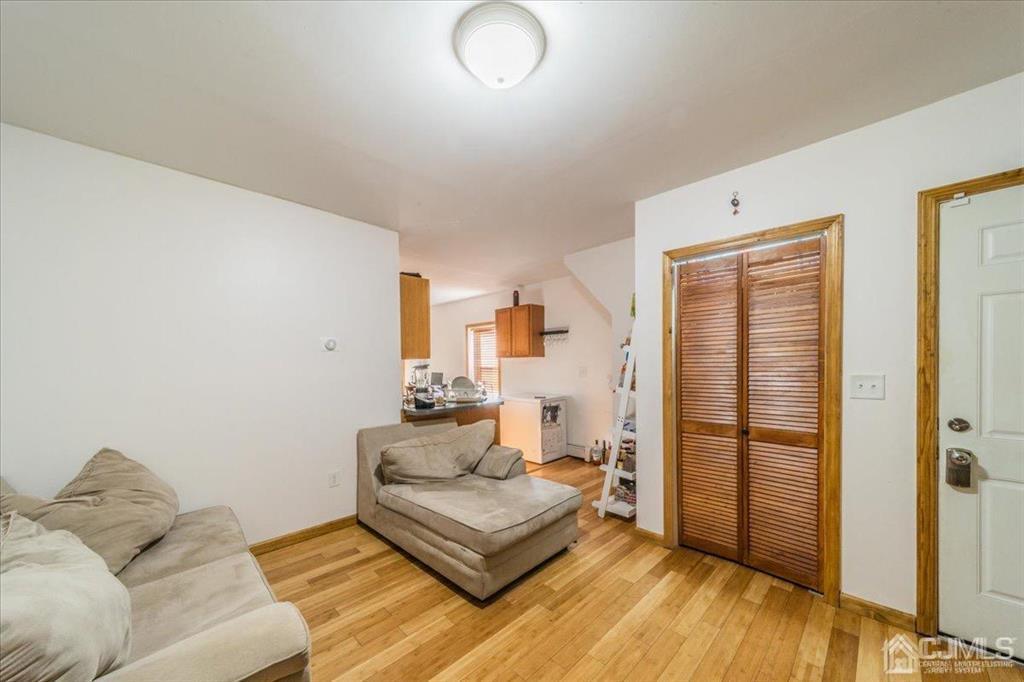 28 Union Street Carteret, NJ 07008 - Photo 4 of 25 a living room with furniture and wooden floor