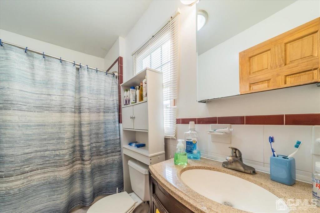 28 Union Street Carteret, NJ 07008 - Photo 7 of 25 a bathroom with a sink a toilet and shower